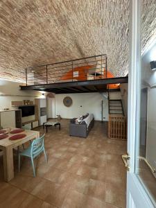 a living room with a loft bed and a couch at Dimora Sant'Anna Family Suite in Bernalda
