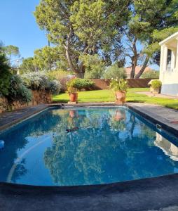 a swimming pool with blue water in a yard at Serene Haven Guest House in Victoria West