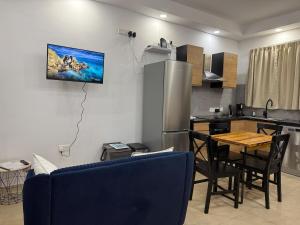 a kitchen with a table and chairs and a refrigerator at 4 Bed Maisonette Close to Mater Dei in Birkirkara