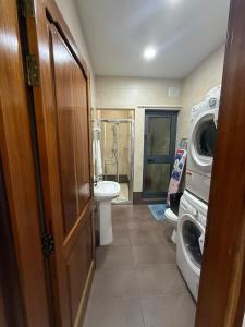 a bathroom with a washing machine and a washer and dryer at 4 Bed Maisonette Close to Mater Dei in Birkirkara
