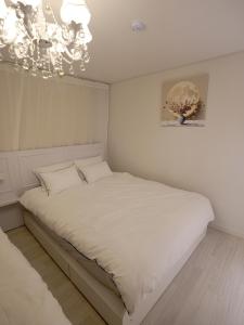 Ένα ή περισσότερα κρεβάτια σε δωμάτιο στο Gwangalli Beach 1min #2BR #Couple #Family Stay #drone show #fireworks spot #BUSAN #Golden #영화제 #골든 +25 φωτογραφίες