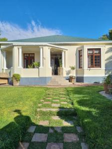 a house with a green lawn in front of it at Serene Haven Guest House in Victoria West