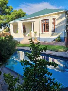 a house with a swimming pool in front of it at Serene Haven Guest House in Victoria West +175 photos