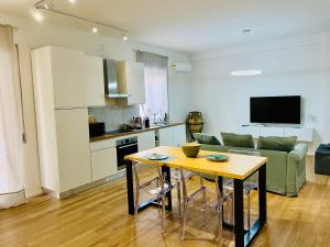 a kitchen and living room with a table and a couch at Domus Lucia in Syracuse