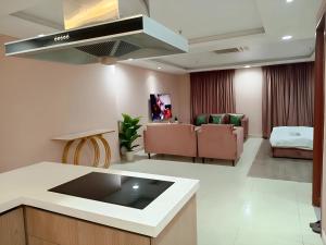 a living room with a kitchen and a living room with couches at Gold Crest Premium Hotel Serviced Apartments DHA Phase 4 Lahore in Lahore +54 photos