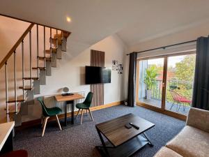 a living room with a staircase and a table at Boutique Spa apartment with Balcony & River Views in Norwich