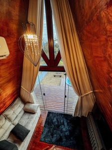 a room with a large window and a chandelier at Chalé mirante do Sol in Socorro +28 photos