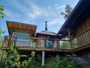 a house with a wrap around porch and a deck at Rock House, Lake Saimaa in Savitaipale