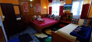 a small room with two beds and a window at Homestay Blue Horizon in Darjeeling +3 photos