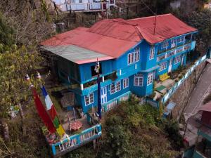 an overhead view of a blue house with a red roof at Homestay Blue Horizon in Darjeeling