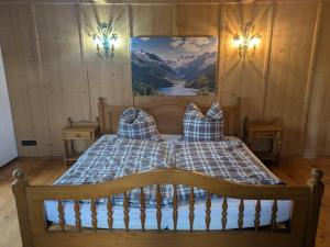 a bedroom with a bed with a picture on the wall at Idyllische Maisonettewohnung mit Bergblick in Irschenberg +27 photos