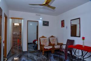 a living room with two chairs and a table at kolkumalai tent stay in Suryanelli