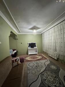 a living room with a couch and a rug at Tekinler Deluxe Suite in Diyarbakır
