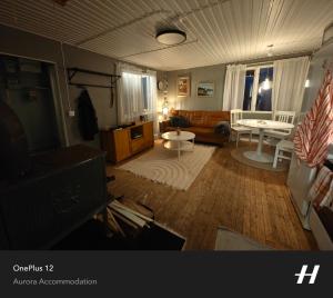 a living room with a couch and a table at Aurora Lakeside Cabin Altajärvi in Kiruna