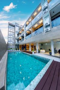 an exterior view of a building with a swimming pool at Sky Beach Maldives - Dhiffushi in Dhiffushi