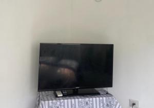 a flat screen tv sitting on top of a table at R suite in Netanya