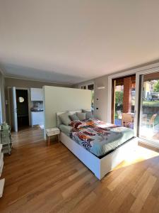 a bedroom with a bed and a large window at Il Canneto in Lomnago