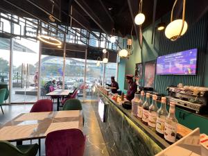 a restaurant with a bar with bottles of wine at Gold Crest Premium Hotel Serviced Apartments DHA Phase 4 Lahore in Lahore