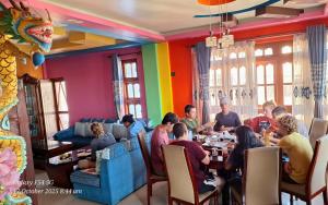 a group of people sitting at a table in a restaurant at Dragon Homestay Bhaktapur in Bhaktapur