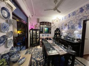 a room with blue and white plates on the wall at On The House Boutique Bed Breakfast with Terrace Garden Views in New Delhi