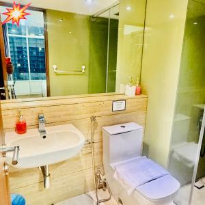 a bathroom with a sink and a toilet and a mirror at vortex luxury apartment klcc in Kuala Lumpur
