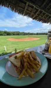 a plate of food with a sandwich and french fries at Diani's Little Gem in Ukunda