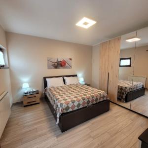 Un dormitorio con dos camas y un espejo. en Villa Dall'Angelo Suite Mountain Lake Endine Hospitality, en Endine Gaiano