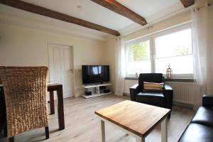 a living room with a couch and a tv at Ferienhaus Weideblick in Hymendorf