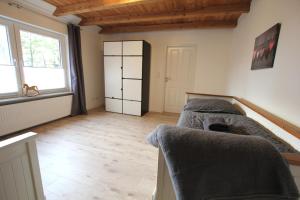 a living room with two beds and a window at Ferienhaus Weideblick in Hymendorf