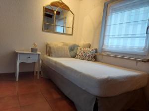 a bed sitting in a room with a window at La Maison Kouglof in Nordheim