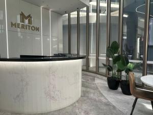 a lobby with a reception desk in a building at Meriton Parramatta in Sydney +4 photos