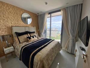 a bedroom with a large bed and a large window at Large Sea View Room Quiet Side Copacabana in Ban Nong Pru