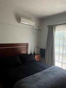 a bedroom with a bed and a window at Duplex 1 Villa Ramallo in Estación Ramallo +19 photos