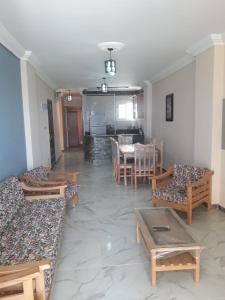 a room with couches and a table and a dining room at مرسي مطروح شقه مفروشه سوبر مطله علي فيو بانوراما للبحر in Marsa Matruh +4 photos
