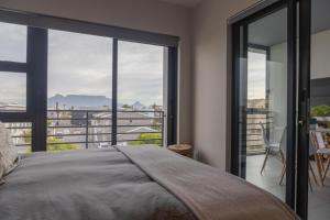 Ένα ή περισσότερα κρεβάτια σε δωμάτιο στο 8 Blue Tides Premium Blouberg Apartment with Table Mountain View