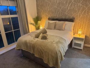 a bedroom with a large bed with a large window at The Contractor Condo - Underground Parking in Aylesbury