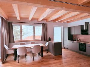 a kitchen and dining room with a table and chairs at Ferienwohnungen Zwergbirke in Thomatal +20 photos