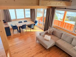 a living room with a couch and a table with chairs at Ferienwohnungen Zwergbirke in Thomatal