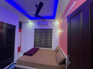 a bedroom with a bed with a blue ceiling at Rainbow apartments in Cochin