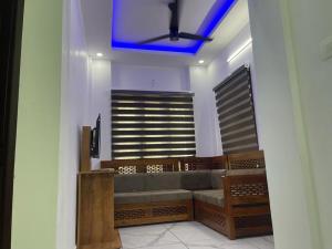 a room with a couch and a blue ceiling at Rainbow apartments in Cochin