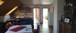 a kitchen and a living room with a table at Ubytovanie michaela in Bešeňová