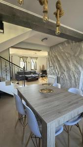 a living room with a large wooden table and chairs at Pointview House Gesha in Dryanovo