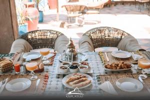 a table with food and drinks on it at Jnane Ayam Atlas in Ourika