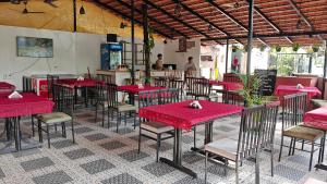 a group of tables and chairs in a restaurant at Palolem Casa in Canacona