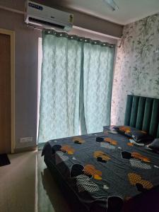 a bedroom with a bed with a blanket on it at My Private Space in Ludhiana