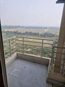 a balcony with a view of a field and a fence at My Private Space in Ludhiana