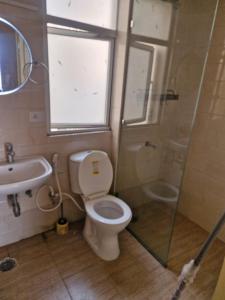a bathroom with a toilet and a sink and a shower at My Private Space in Ludhiana