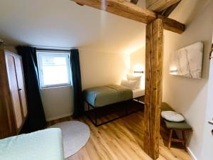 a small room with a small bed and a window at Dein Eifelhaus in Langenfeld