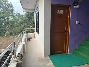 a door to a building with stairs and a stair case at The Kapil Homestay in Manamaiju