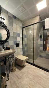 a bathroom with a shower and a toilet and a sink at Liora Hotel in Sanlıurfa +77 photos